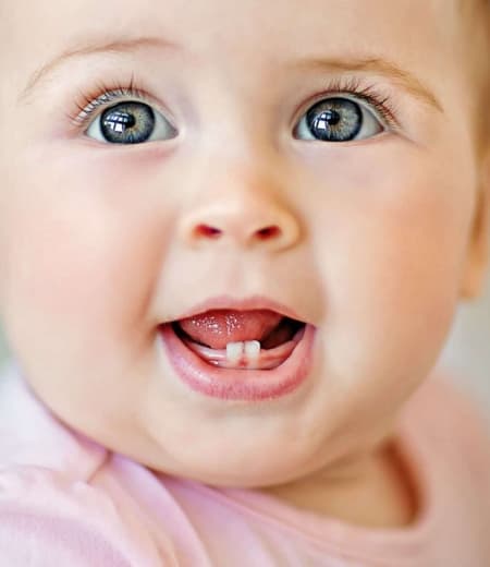 Young girl holding Moore Orthodontics t-shirt