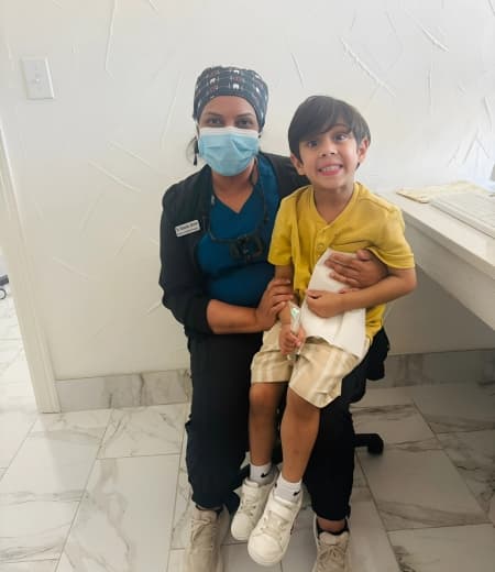 Young girl holding Moore Orthodontics t-shirt