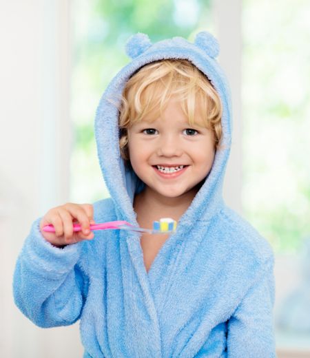 Young girl holding Moore Orthodontics t-shirt
